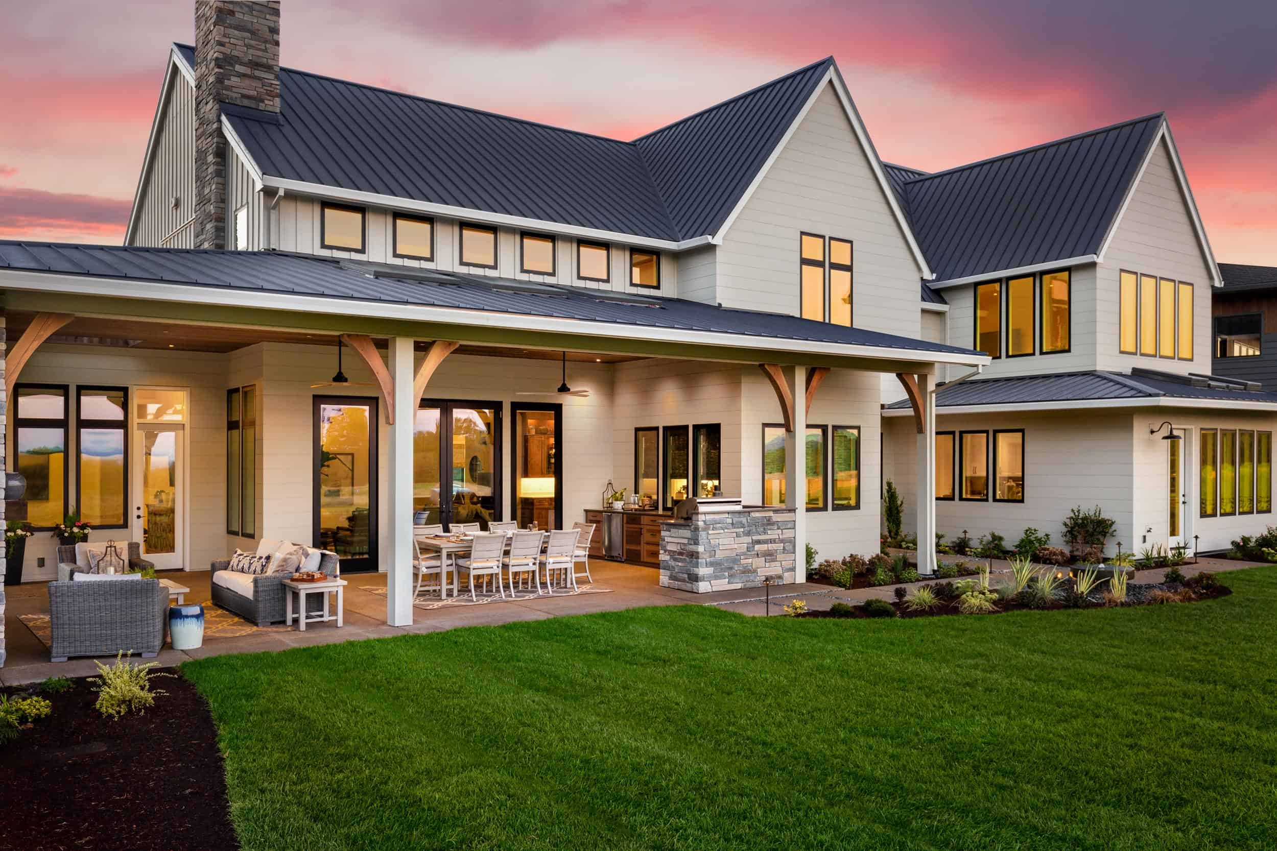 New luxury home exterior at sunset. Features large covered patio